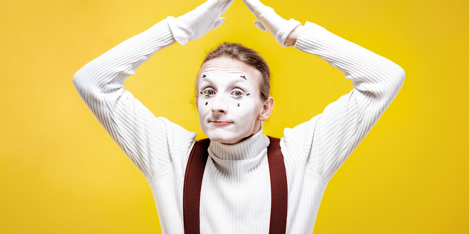 canva Ein Mann ist als Pantomime verkleidet und streckt seine Hände über den Kopf